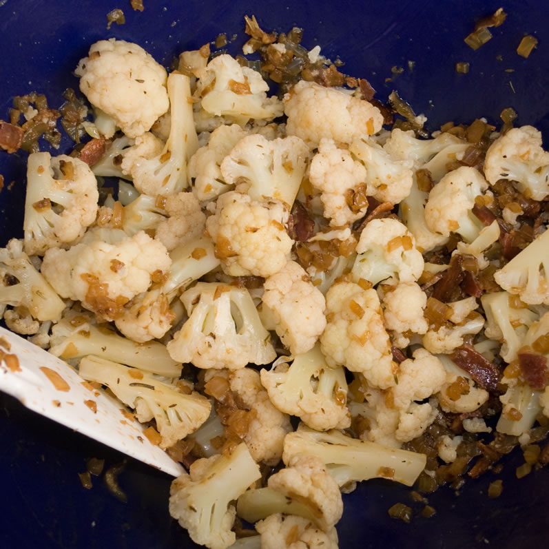 Mixing Cauliflower, Bacon, and Caramelized Onions